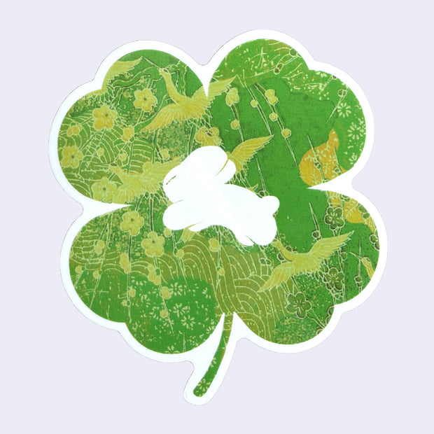 Die cut sticker of a four-leaf clover design with a small white bunny in the center.
