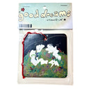 Square air freshener with an illustration of a grassy hill with small angel characters and bunnies.