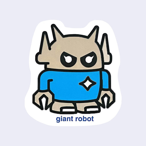 Die cut sticker of a small, grey chibi style robot in a blue long sleeve shirt with a white spark on its right chest. Below, "giant robot" is written in lowercase blue font.