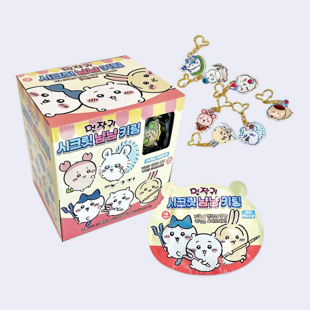 Display case for Chiikawa blind bagged keychains, with different Chiikawa characters as acrylic charms.