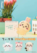 Cute animal-shaped clips on a blue background with a plant and small building model.