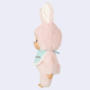 Plush toy in a pink bunny costume a blue laced bib that reads 'Chimutan' on a light purple background