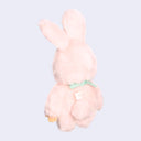 Pink plush toy on a light purple background