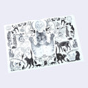 Open 2 page book spread of black and white cat-themed illustrations on a light gray background