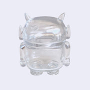 Clear soft vinyl figure with empty insides. Figure is shaped like a smaller Big Boss Robot, with a bigger head than normal and two clear outlined eyes with sparkles as pupils. A clear outlined heart is on its upper right chest. Back view.