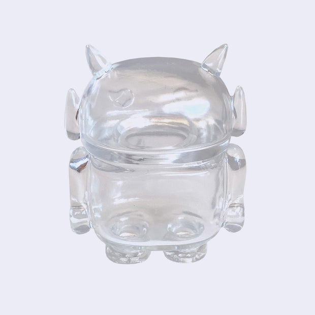 Clear soft vinyl figure with empty insides. Figure is shaped like a smaller Big Boss Robot, with a bigger head than normal and two clear outlined eyes with sparkles as pupils. A clear outlined heart is on its upper right chest. Back view.
