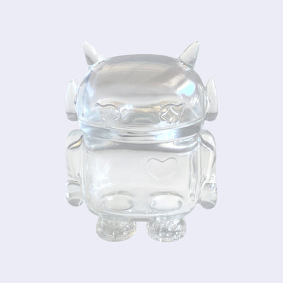 Clear soft vinyl figure with empty insides. Figure is shaped like a smaller Big Boss Robot, with a bigger head than normal and two clear outlined eyes with sparkles as pupils. A clear outlined heart is on its upper right chest.