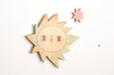 Wooden sun-shaped wall decor with a gradient finish on a white background