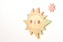 Sun-shaped die cut wooden art piece with a star on a white background