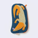 Oval shaped navy blue pouch with an orange zipper and an illustration of an orange crocodile with green scales. It has sharp teeth and a small purple butterfly rests on its snout.
