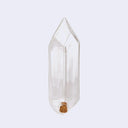 Water From a Crystal, a crystal shaped glass container that you fill with water and place in a potted plant to self water over the course of 3-4 days. 