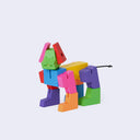 Colorful toy dog figure made of interlocking blocks on a light purple background