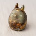 Ceramic sculpture of Totoro, covered in a bronze coloring with the effect of raku fired ceramics.