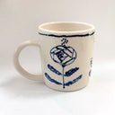White mug with blue floral design on a white background