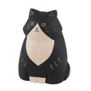 Wooden cat figurine with black and white color on a white background