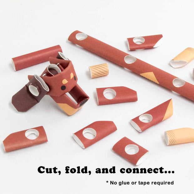 Partially assembled paper sculpture of a dachshund, made out of cut paper pipes.