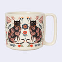 Mug with black cat and floral design on a white background