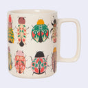 White mug with illustrations of patterned beetle bugs.