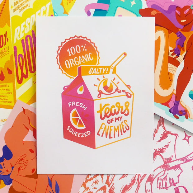 Graphic illustration on white paper of a orange and pink small juice carton. A white bendy straw pokes through an eye as the opening and the front reads "Tears of my enemies"