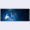 Person holding a flaming object in a dark, possibly futuristic setting
