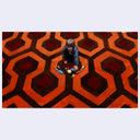 Person standing on a red and black patterned carpet, reminiscent of 'The Shining' movie scene.