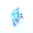 A small ceramic dog figurine with a light blue and white marbled pattern, featuring an open mouth showing pink mouth, white teeth, set against a plain white background.