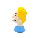 A small sculpted bust figure of a cartoon-style man with bright yellow hair, a beige face, black facial details, and a blue shirt on a plain white background.