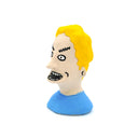 A small sculpted bust figure of a cartoon-style man with bright yellow hair, a beige face, black facial details, and a blue shirt on a plain white background.