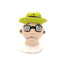 A handcrafted clay figurine of a man's head wearing a bright lime green hat and black-rimmed glasses with white circular lenses, set against a plain white background.
