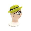A handcrafted clay figurine of a man's head wearing a bright lime green hat and black-rimmed glasses with white circular lenses, set against a plain white background.