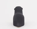 Back view of a black sea otter figurine. 