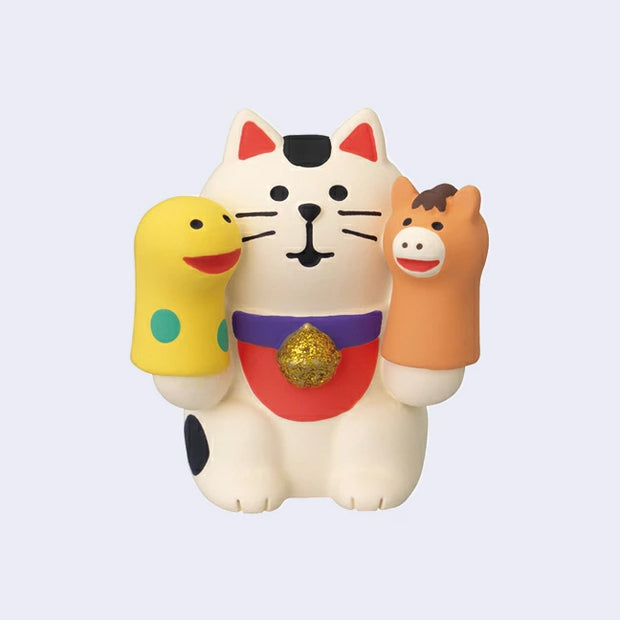 Toy figure of a cat with two hand puppet figures on a light purple background