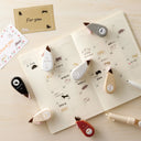Collection of decorative paper cutters with animal designs on a wooden surface