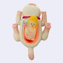 Underside of a white vinyl cat with a nude couple within its under belly, in the middle of a sexual act.