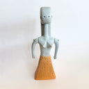 Clay sculpture made to look like an ancient idol of a woman, with simplistic features and unique shapes for her body.