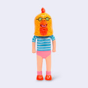 Vinyl figure of a woman wearing a blue striped shirt and pink underwear. Atop her head is a large chicken head, yellow with an orange beak and glasses.