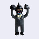 Vinyl figure of a Satoshi Yamamoto, a Japanese business man, painted in a black and grey color scheme including his skin, with a piece of poo on his head and on both of his lifted up hands.
