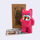 Pink cat-shaped toy with a sushi design in front of a cardboard box labeled 'SUSHIZU'.