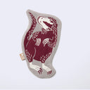 Die cut fabric coaster, shaped to the design of a burgundy raptor-like dinosaur perched on its hindlegs with small arms. Border is beige.