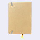 Backside of a grayish yellow pleather covered journal with an elastic closure and a shiny yellow page marking ribbon.