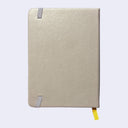 Backside of a brownish gray pleather covered journal with an elastic closure and a shiny yellow page marking ribbon.