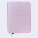 A light pink textured hardcover notebook with a white embossed cartoon robot logo on the front cover and a mint green ribbon bookmark peeking out from the bottom.