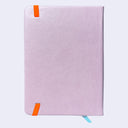 A light pink textured notebook with two orange elastic bookmarks and ribbon tabs, shown on a clean light gray background.