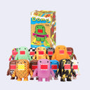 Colorful Domo vinyl toys with a box in the background on a light purple background