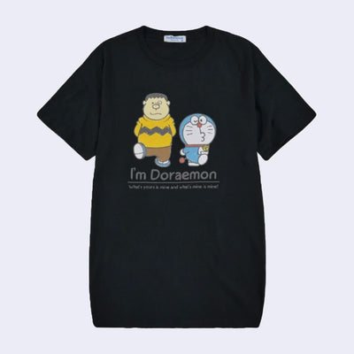 Black t-shirt featuring a graphic of Doraemon and a human wearing a Charlie Brown esque shirt. They both walk and kick up one foot. Below, reads "I'm Doraemon!"