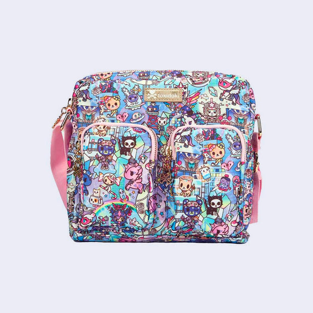 Crossbody purse with 2 front pockets and a long strap. Features pastel pink colored fabric detailing, around the zipper and as the handles/straps. Bag has a small "tokidoki" nameplate on the upper center and is covered completely in a busy colorful pattern featuring tokidoki characters with with galactic and sci fi imagery. 