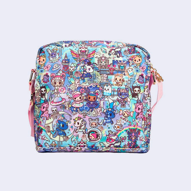Crossbody purse with 2 front pockets and a long strap. Features pastel pink colored fabric detailing, around the zipper and as the handles/straps. Bag has a small "tokidoki" nameplate on the upper center and is covered completely in a busy colorful pattern featuring tokidoki characters with with galactic and sci fi imagery. Back view.