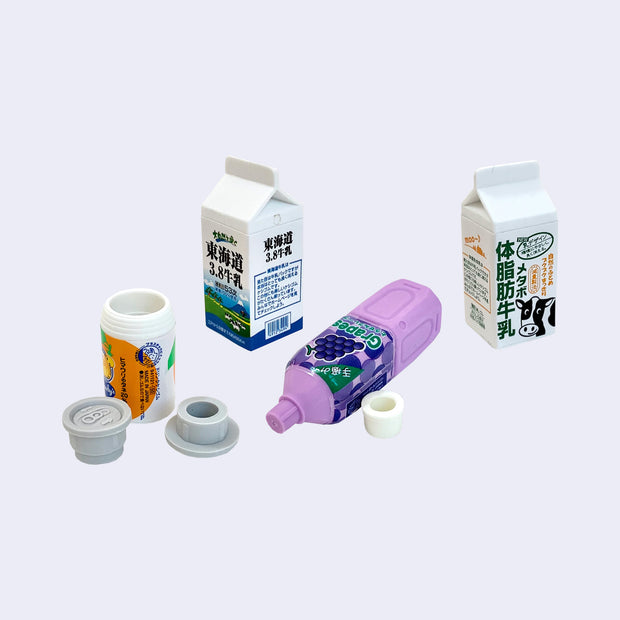 4 small erasers made to resemble drinks, such as cartons of milk and fruit juice or soda bottles.