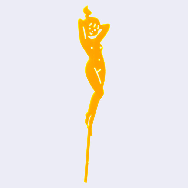 Orange die cut drink stirrer of a nude cartoon girl, standing with her arms behind her head and with a ponytail