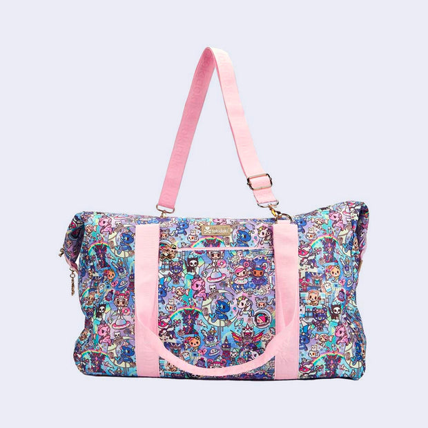 Boxy duffel bag with pastel pink colored fabric detailing, around the zipper and as the handles/straps. Bag has a small "tokidoki" nameplate on the upper center and is covered completely in a busy colorful pattern featuring tokidoki characters with with galactic and sci fi imagery.